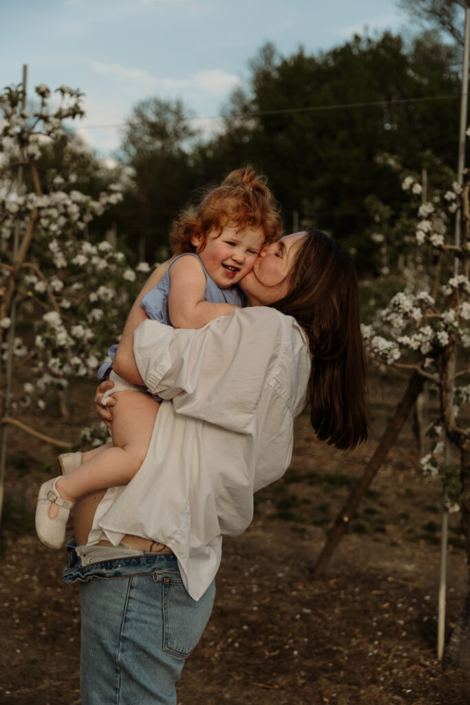 Celebrate new beginnings with newborn and maternity sessions amidst Vermont's breathtaking spring apple blossoms, by Damini Photography