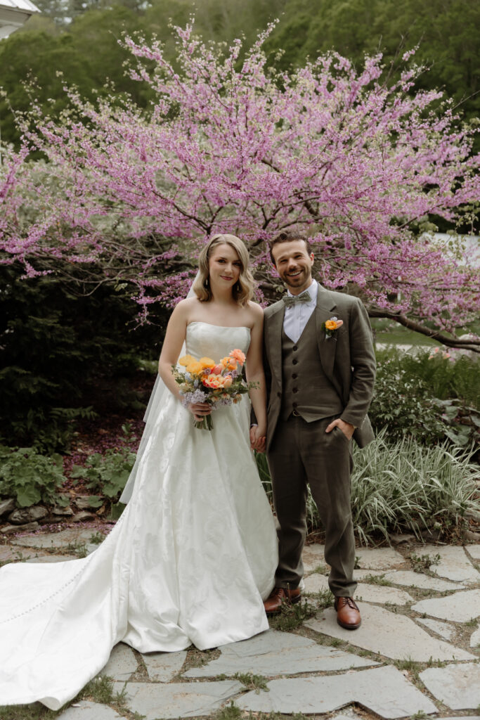 Bride and groom smiling at the camera pose, during portraits at Micro wedding in Vermont.