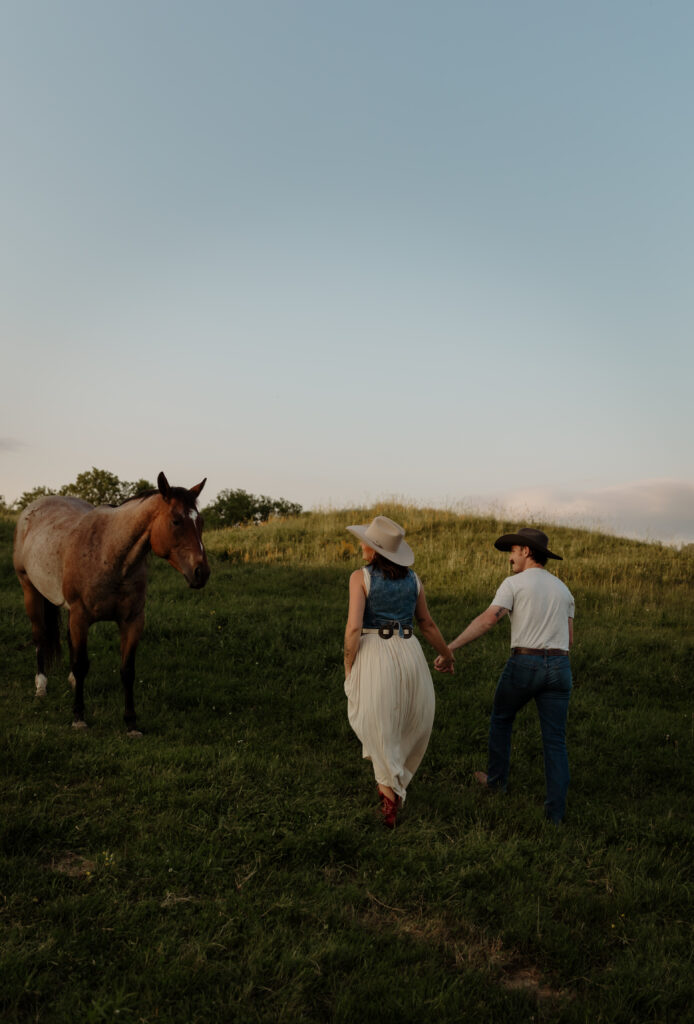 Engaged couple walking through tall grass in Vermont countryside with Outfit Tips for Vermont Engagement and Couples Session