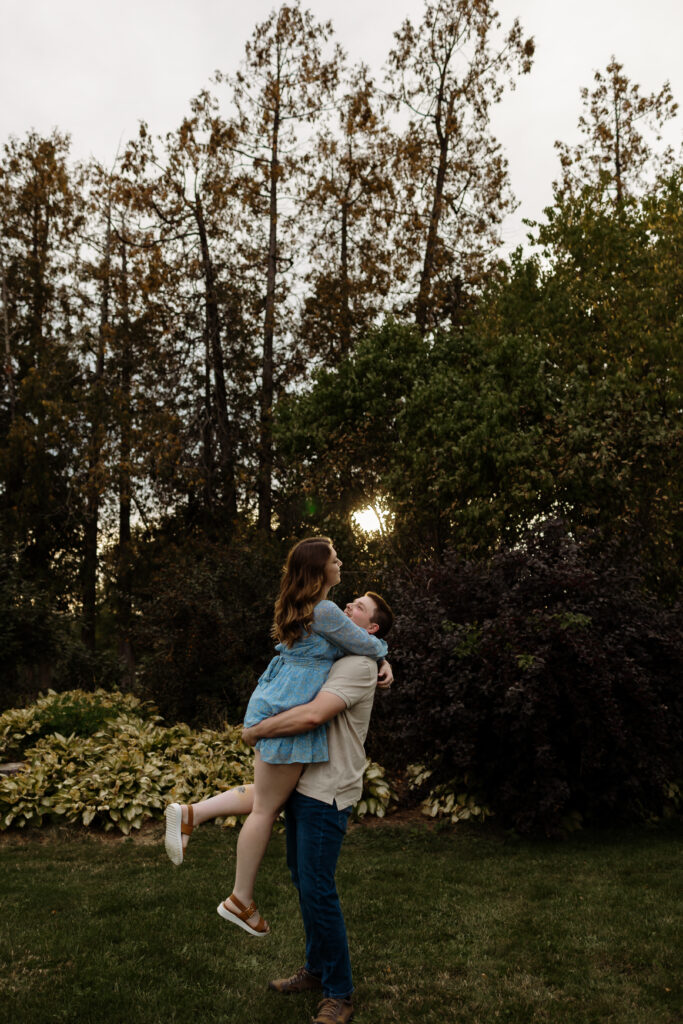 Whimsical golden hour portraits in a New England as the guy twirls his new fiancé during golden hour.