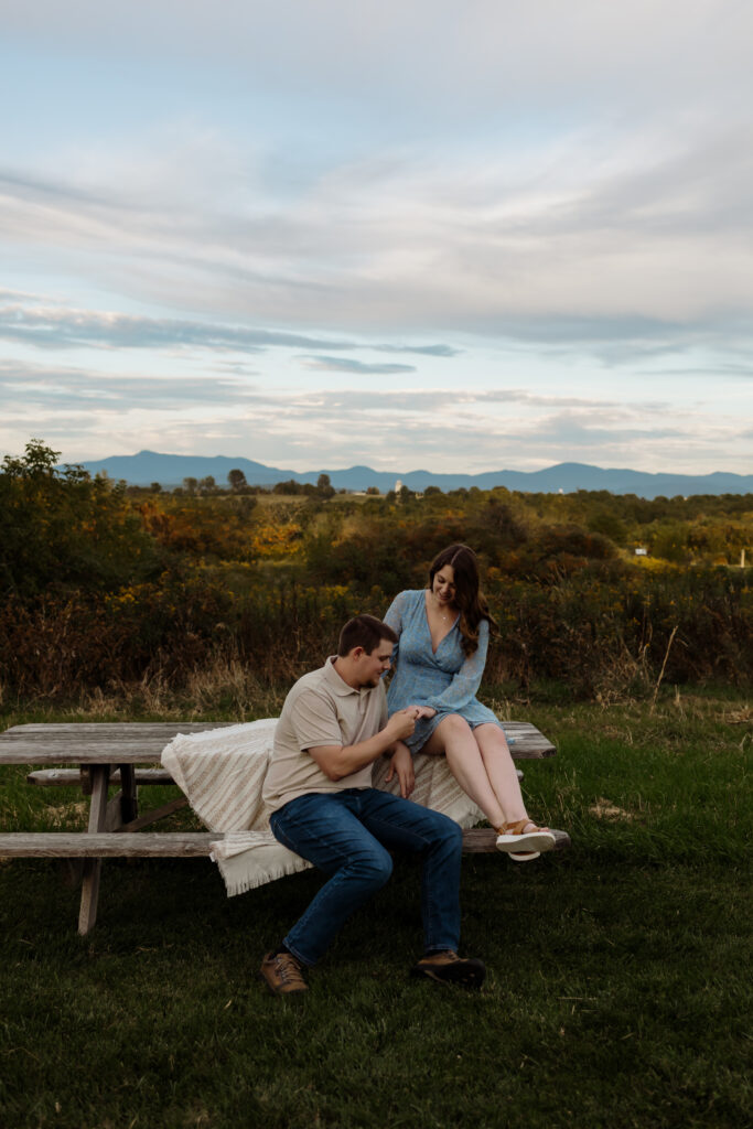 Golden hour couple portraits in field, maroon and cream outfit inspiration