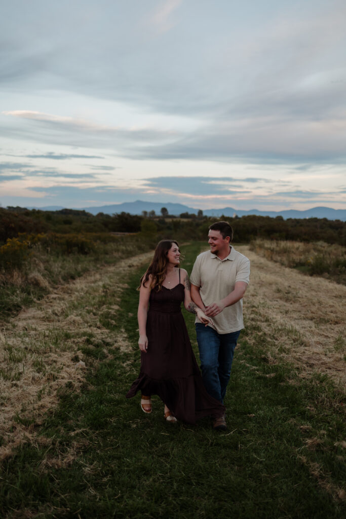 Lifestyle couples photography session in Vermont field during golden hour