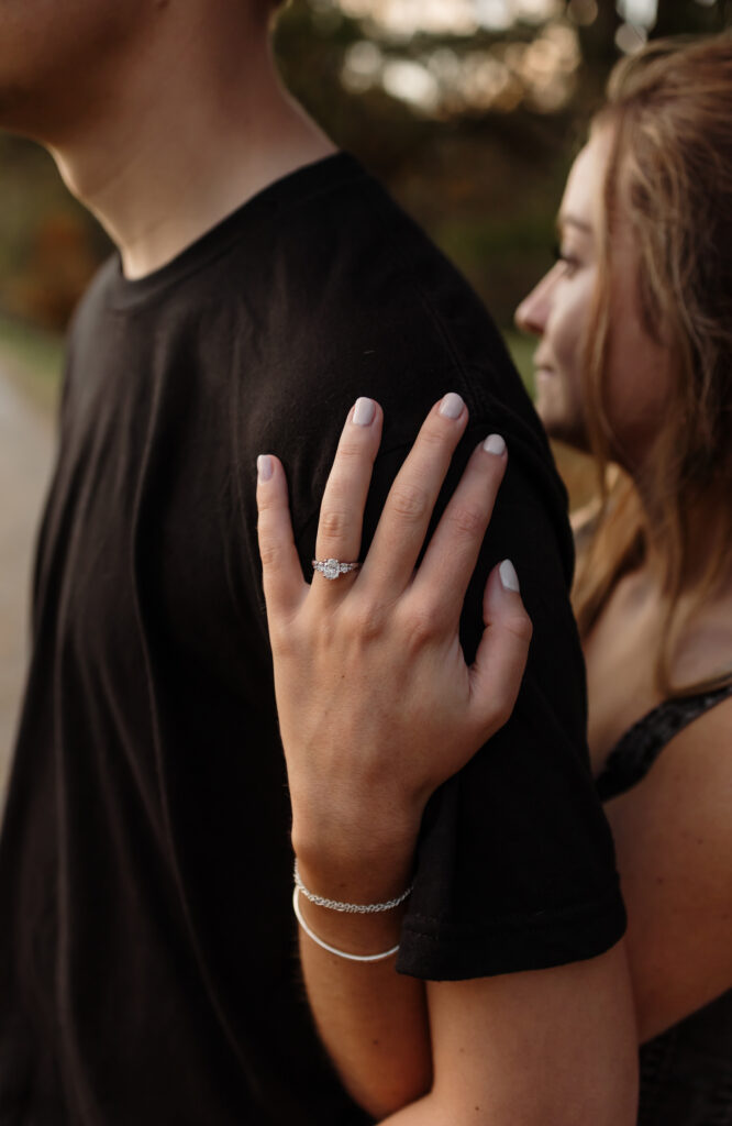 Close-up of engaged couple wrapped in blanket surrounded by fall colors | Intimate photos in Maine
