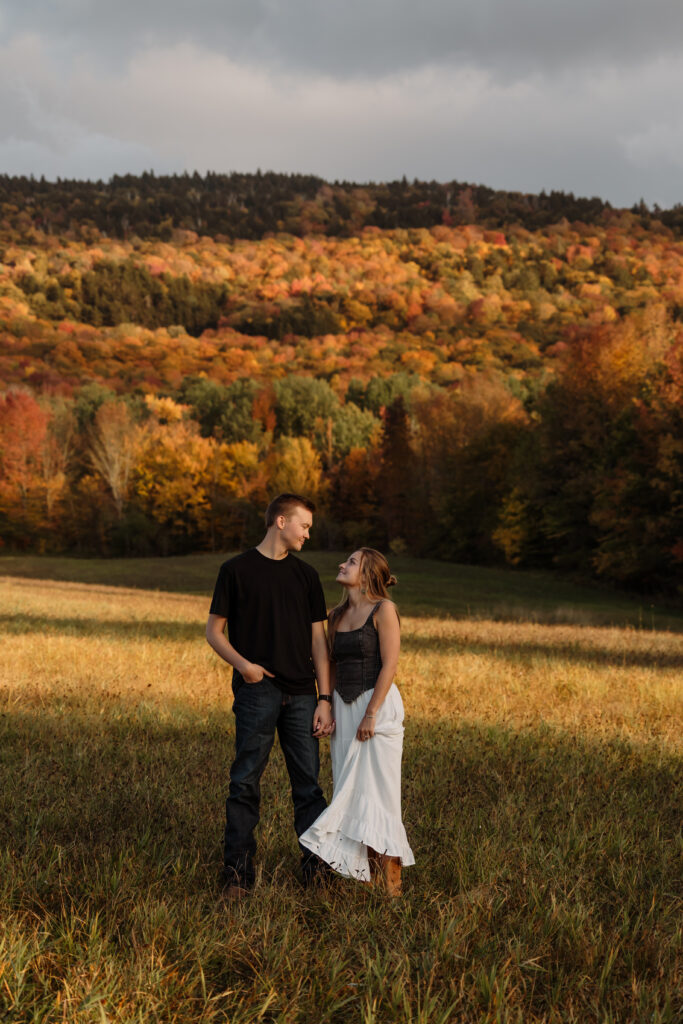 Intimate fall engagement session with warm sunlight and colorful leaves | Rangeley Maine photography