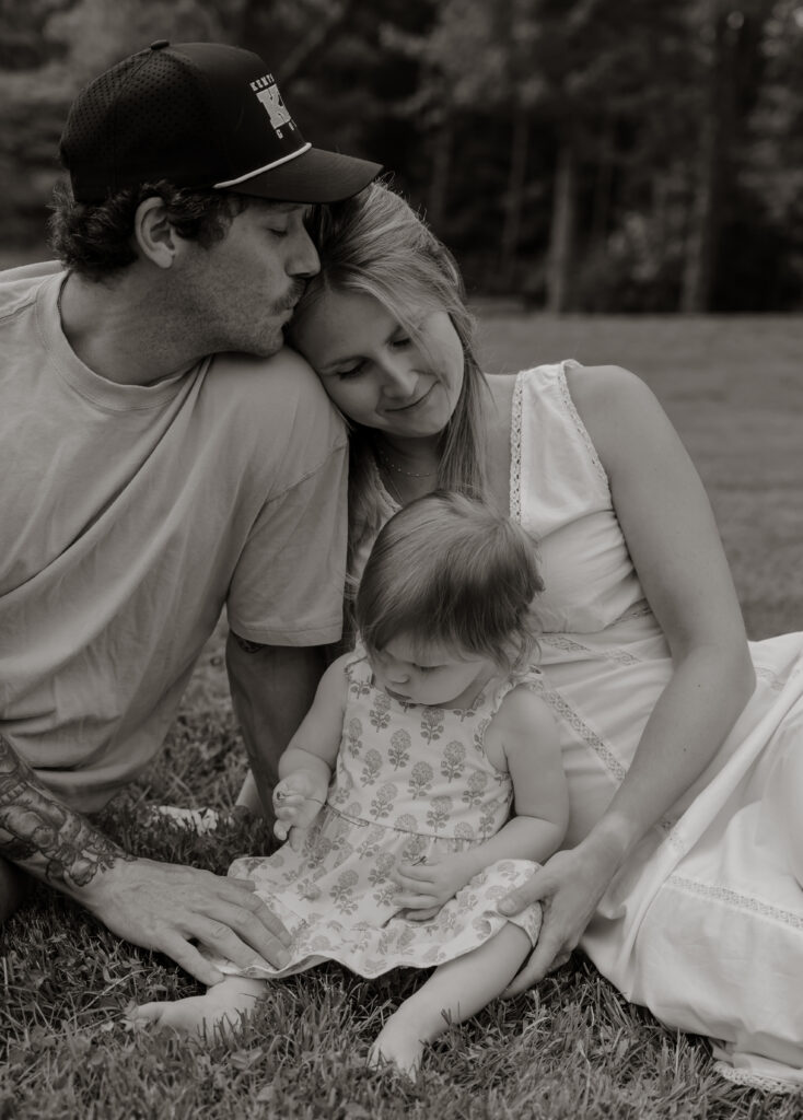 Parents and children sharing a joyful moment during an in-home family photography session in Gardiner, Maine
